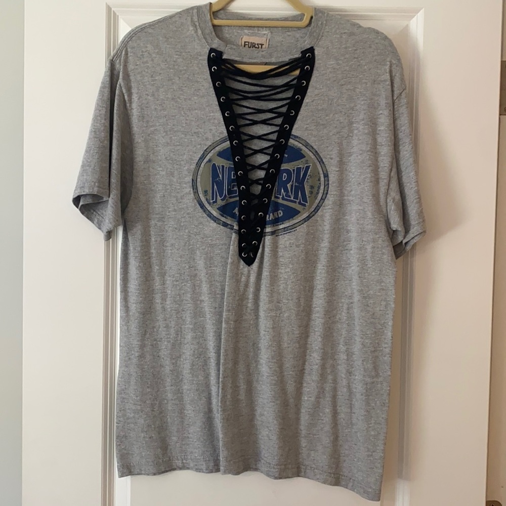 Grey t shirt with black tie in front. New York graphic
